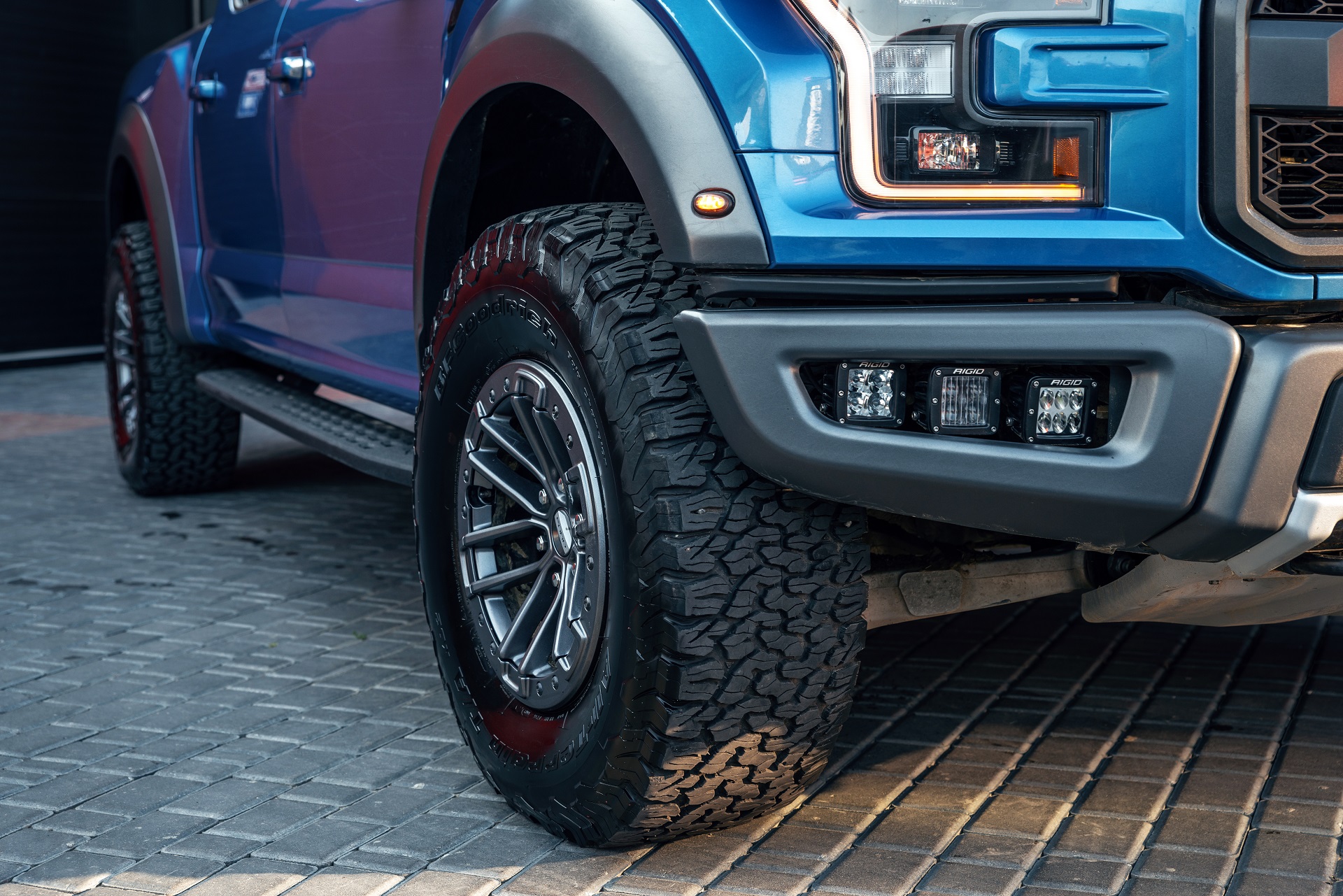 Ukraine, Odessa July 8 - 2021: New Ford Ranger Raptor blue color on the parking. Body detail of the car. Focus on the rear wheel.